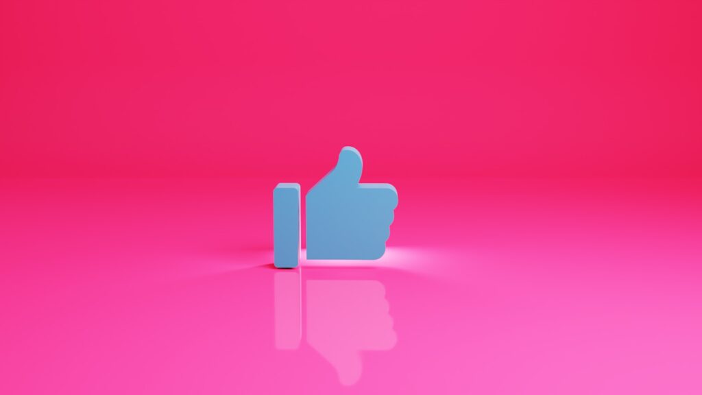 a thumbs up sign on a pink background