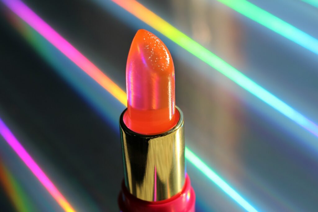 a close up of a lipstick on a reflective surface